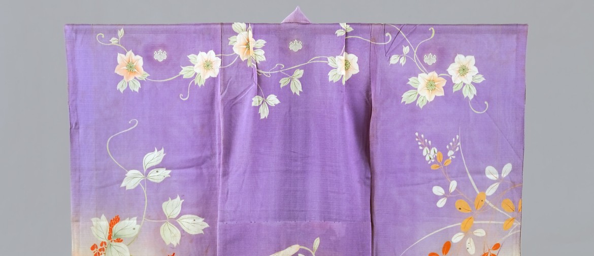 Cropped image of a child's kimono, purple with botanical and floral designs