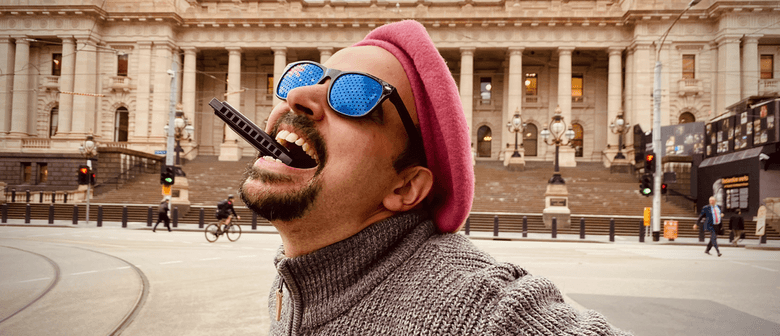 Looming large alongside Victoria's home of democracy, Jeremy Moses, AKA the Bad Slam Poet bites the Harmonica that feeds him.