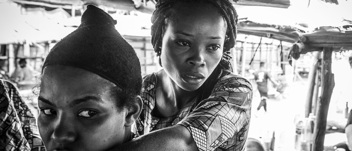 F**K LOSS KISS: Documentary Photographs By Mark Chew A Congolese woman and her friend sells greens from a stall in the Nakivale Refugee Camp Market Place.