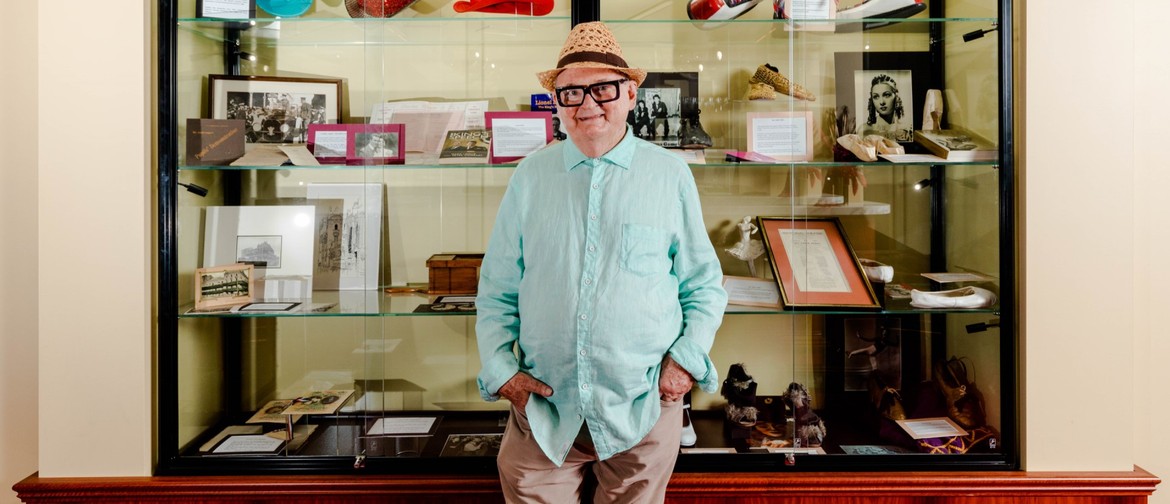 Reflections with Ivan King OAM Historian Ivan King OAM smiles before an exhibition case containing artifacts from the Museum of Performing Arts.