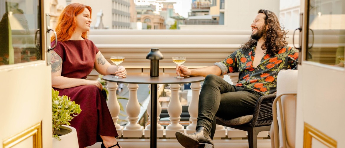 High Cheese Meets High Tea: A Delightful Fusion A young couple drinks champagne on the His Majesty's Theatre balcony.