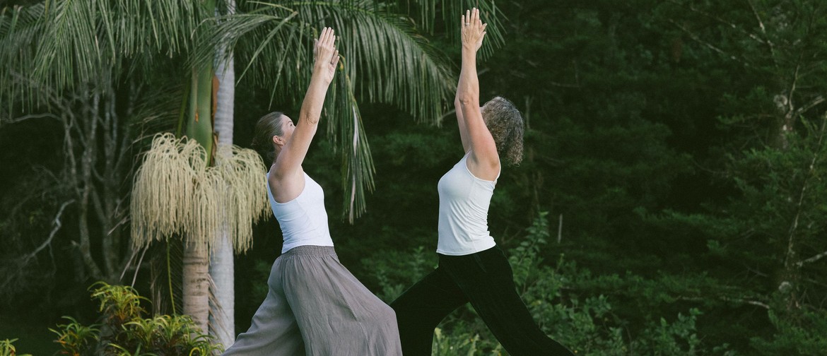 Bundled 7 Day Immersive Two Yoga Therapists in a Yoga posture with garden backdrop
