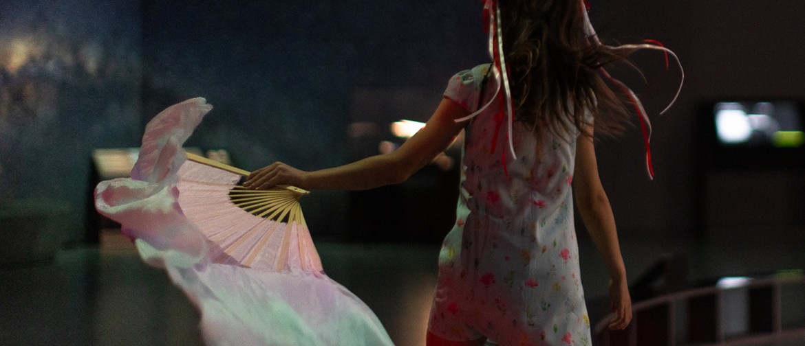 Warrior World: Family Sundays A young girl running with a pastel Chinese fan.