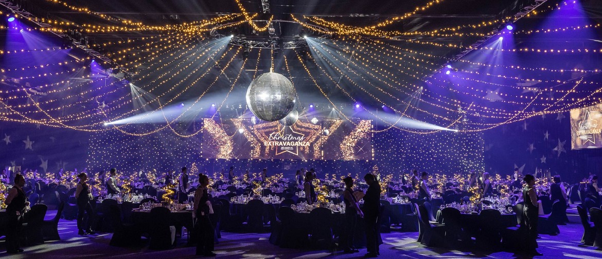 Christmas event in a grand ballroom at the Gold Coast Convention and Exhibition Centre featuring a formal dinner setup, disco ball, fairy lights, and live music entertainment for a festive disco party.