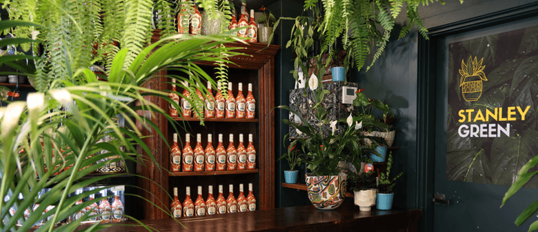 Bar featuring plants, greenery and Baileys bottles in lush settings.