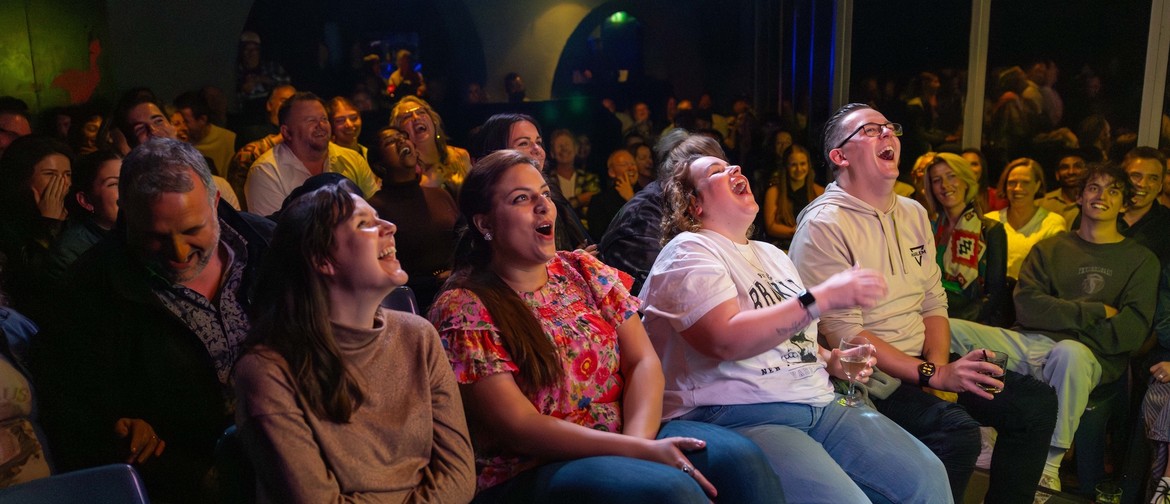 People laughing in a crowd at a kings of comedy show.