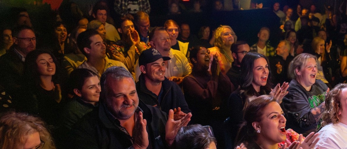 People laughing at a comedy show